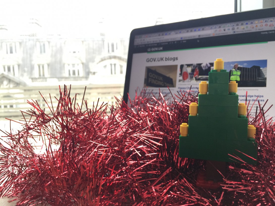 Tinsel and a Lego Christmas tree in front of a laptop showing the GOV.UK blogs homepage