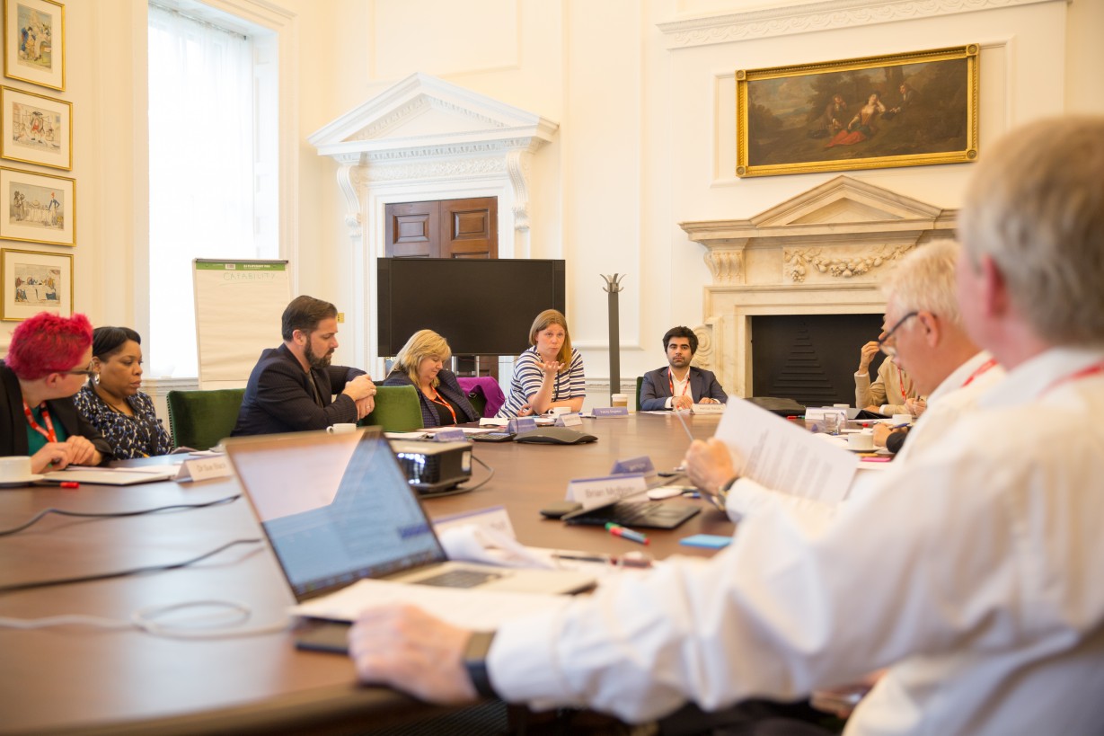 Members of the advisory board around a boardroom table