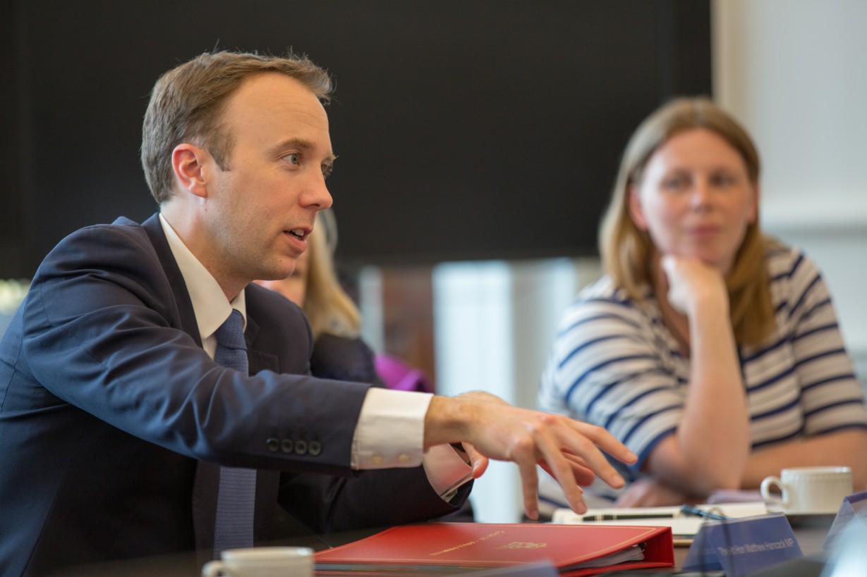 Matt Hancock, MP talking animatedly, Felicity Singleton of GDS listening intently