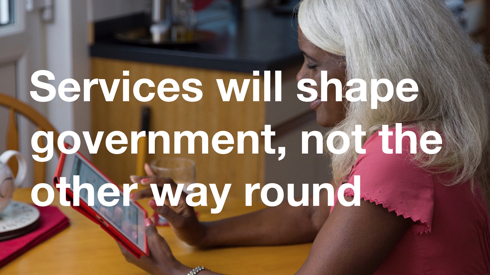 Photo of a woman using an iPad overlaid with the text "Services will shape government, not the other way round"