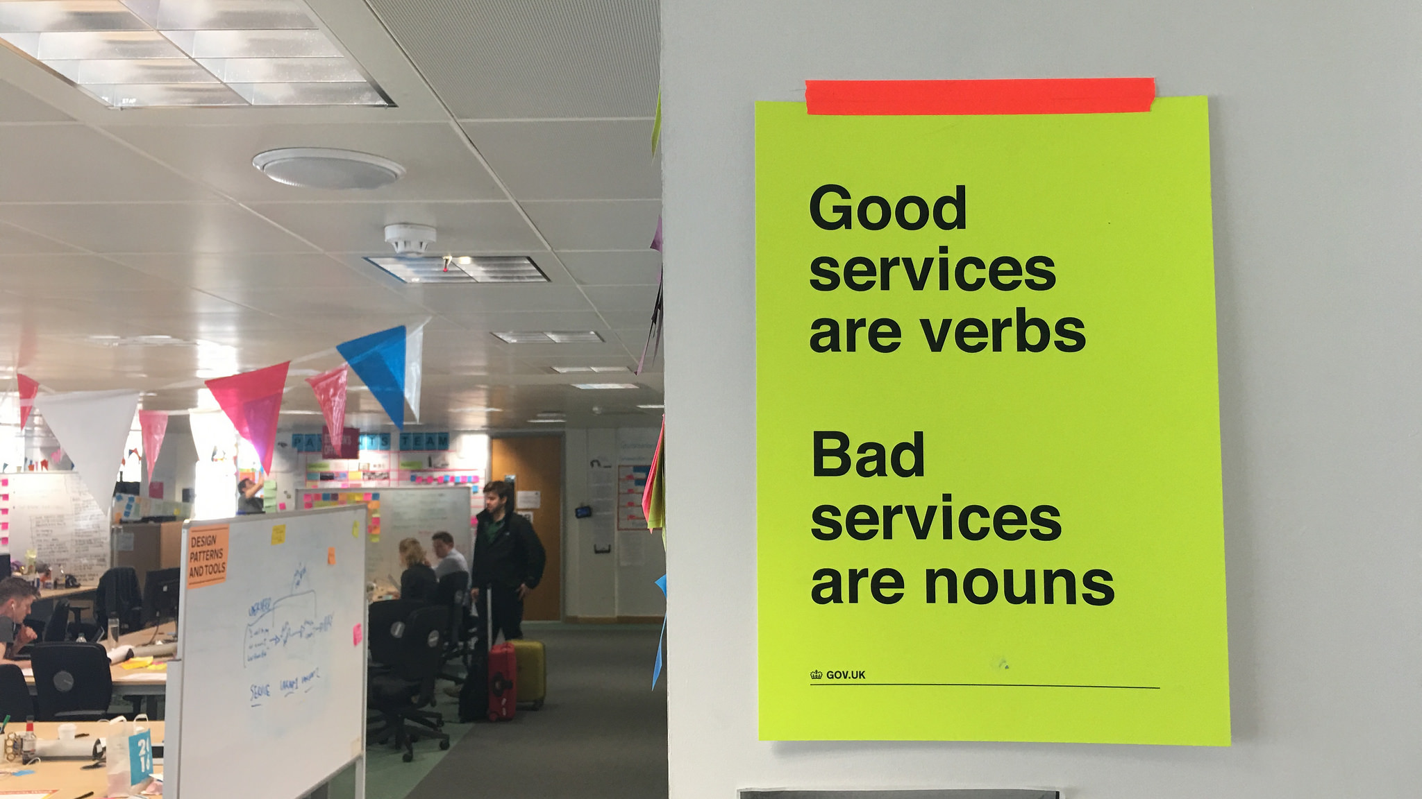Poster with the words 'good services are verbs, bad services are nouns'