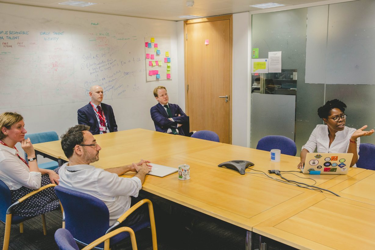 Ben Gummer and others around a table in the GDS office