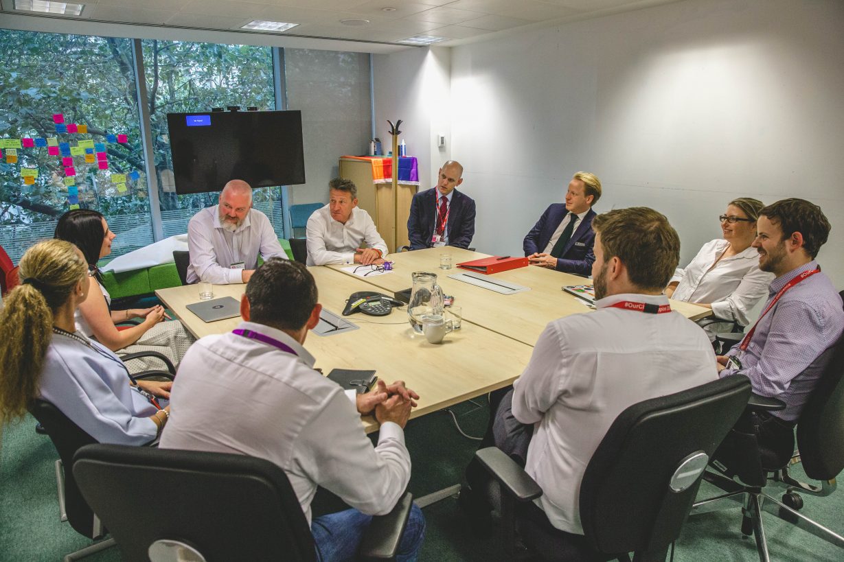 Ben Gummer, Kevin Cunnington and others around a table in the GDS office