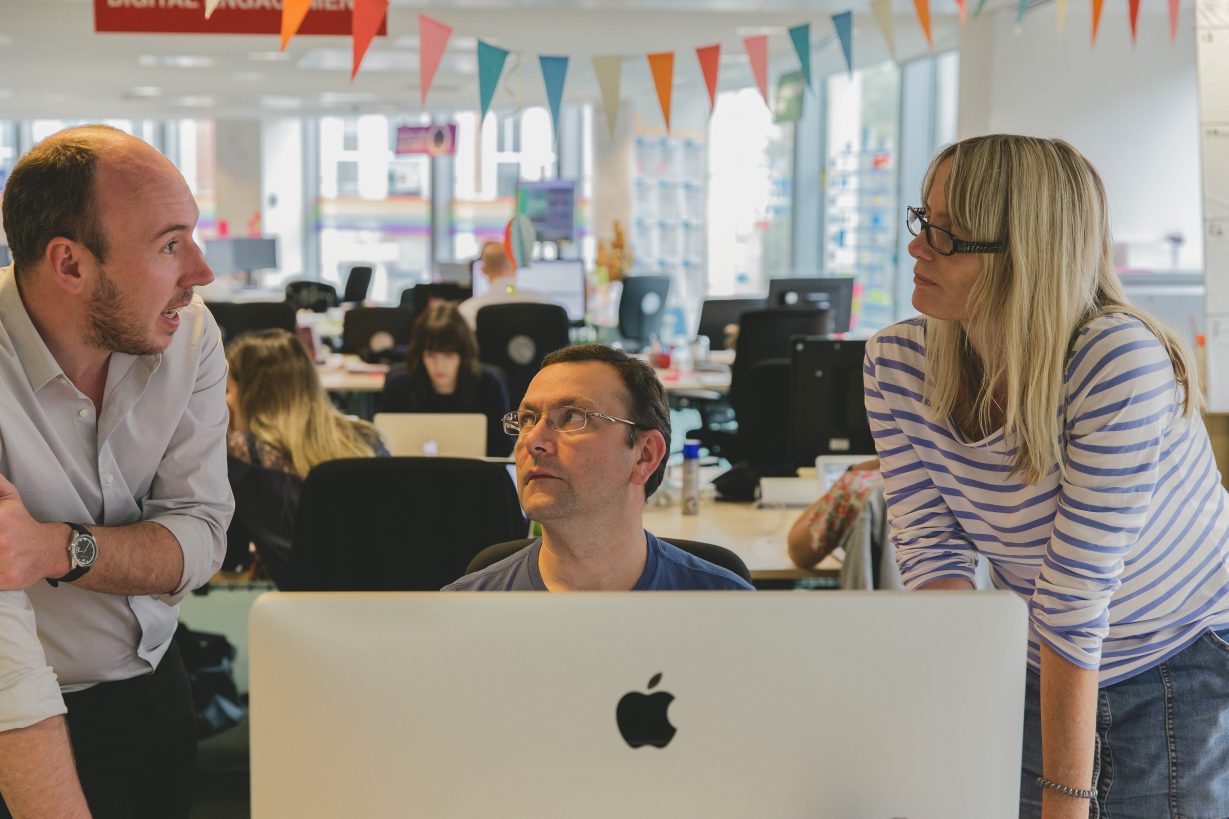 Members of the People Board having a chat at a computer