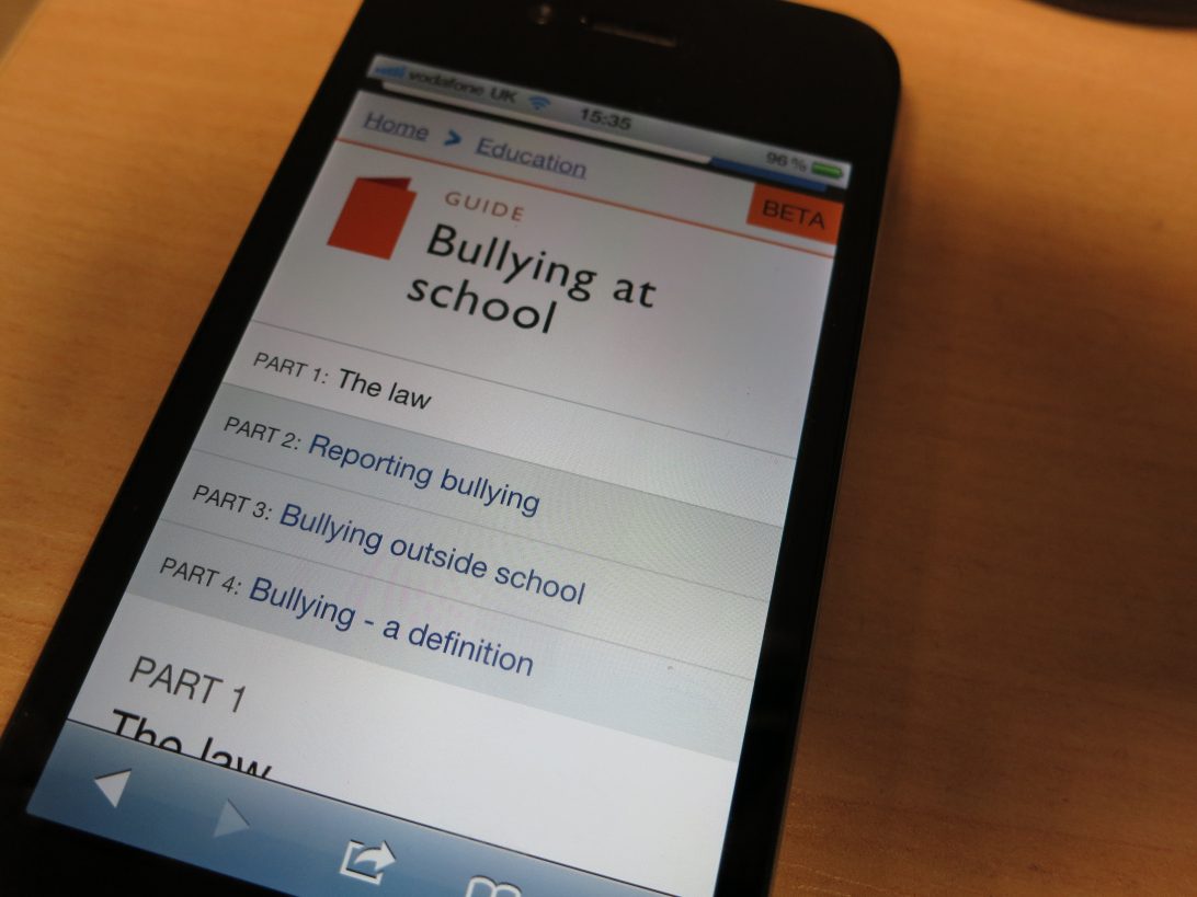 A photo of an iPhone 4 displaying the ‘Bullying at school’ guide on the GOV.UK beta 