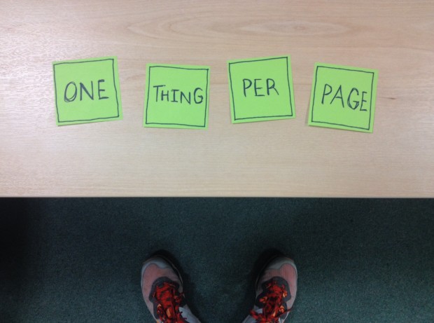 Sticky notes on a desk saying “One thing per page”