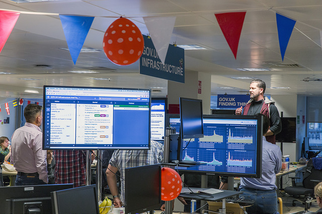 Photo of the GDS office, with Stephen Foreshew-Cain addressing staff while holding a microphone