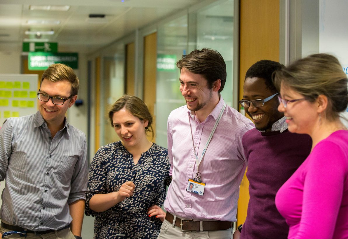 group of people looking at a board