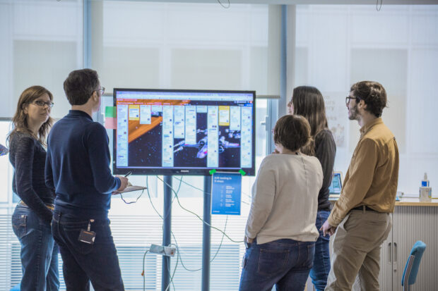 GOV.UK team members in front of a Trello board