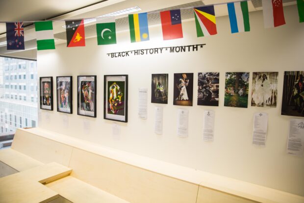 An art gallery set up in the GDS office to celebrate Black History Month - photographs, paintings and international flags.