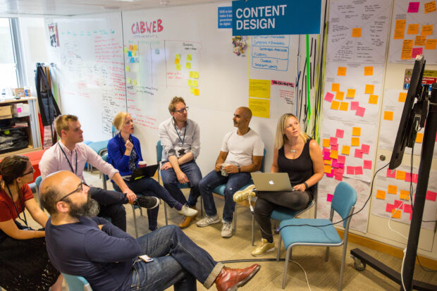 group of people sitting in a circle having a meeting