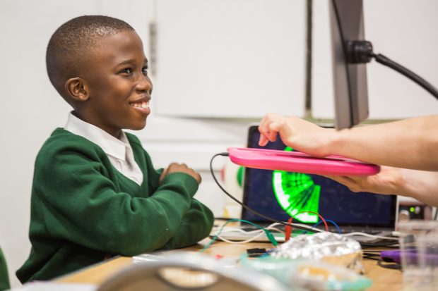 A young boy learning about technology during Tech Day at GDS 