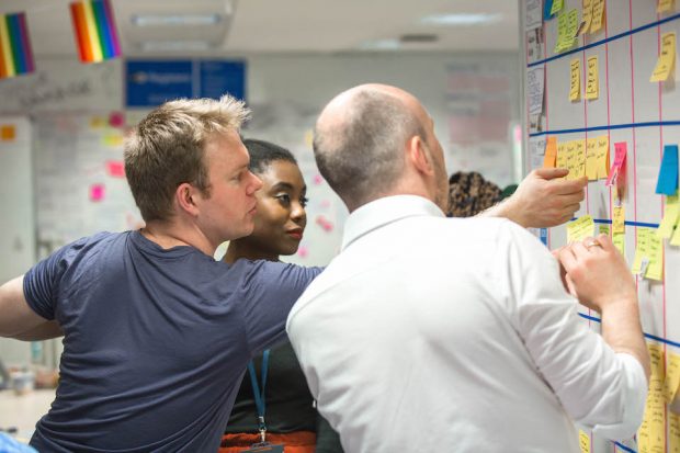 3 GDS staff members in front of a whiteboard