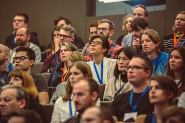 people sitting in a lecture hall listening to a talk