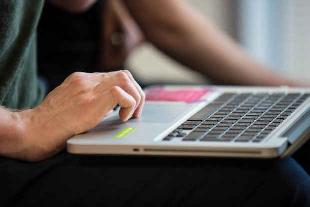 somebody typing on a laptop