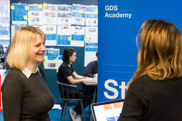 2 people standing in front of a sign reading 'GDS Academy'