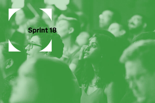 a green image with the Sprint 18 logo and people listening to a talk in the background