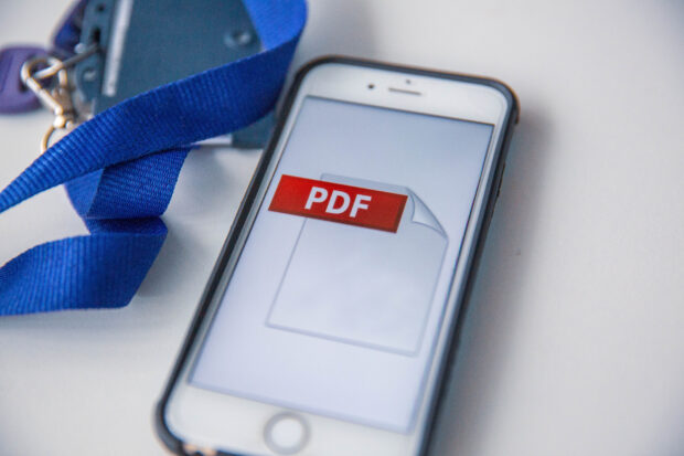 A mobile phone with a PDF logo on the screen