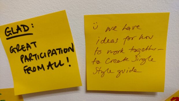 Feedback from the workshop on Post It notes. One says: "Great participation from all!" The second says: "We have ideas for how to work together to create a single guide.