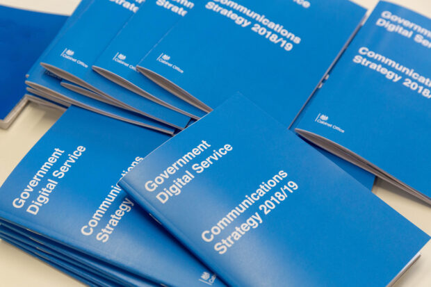 Copies of the GDS Communications Strategy booklet on a table