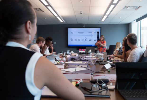 Beverley Smith standing in front of a screen, leading a GDS Academy class with 8 delegates in Ottawa