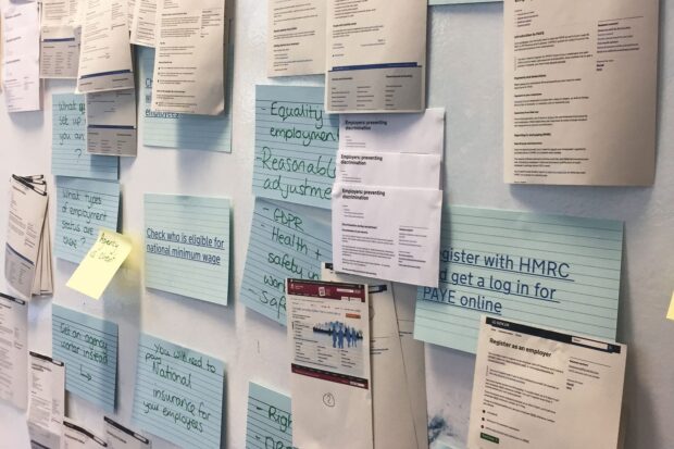 A pin board with lots of cards and paper attached showing different services including 'Register with HMRC and get a log in for PAYE online' and 'Check who's eligible for national minimum wage'