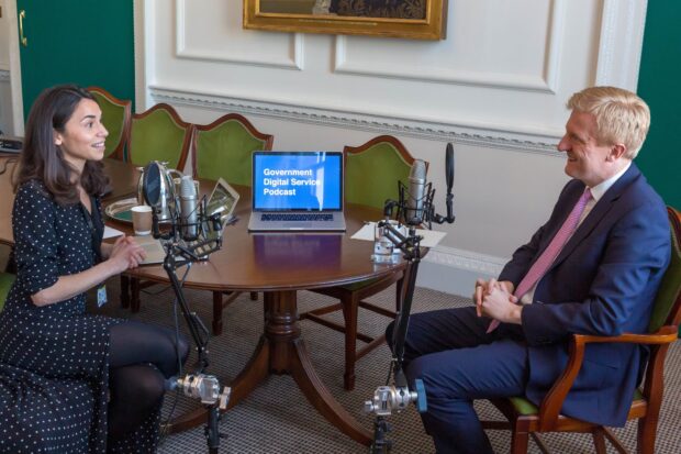 Sarah Stewart (GDS Senior Creative Writer) with minister Oliver Dowden in his Whitehall office, sitting at a desk recording the podcast