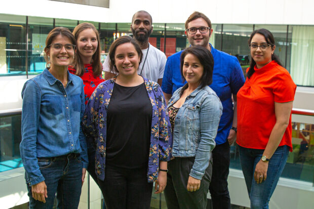 A group of 7 people standing, facing the camera