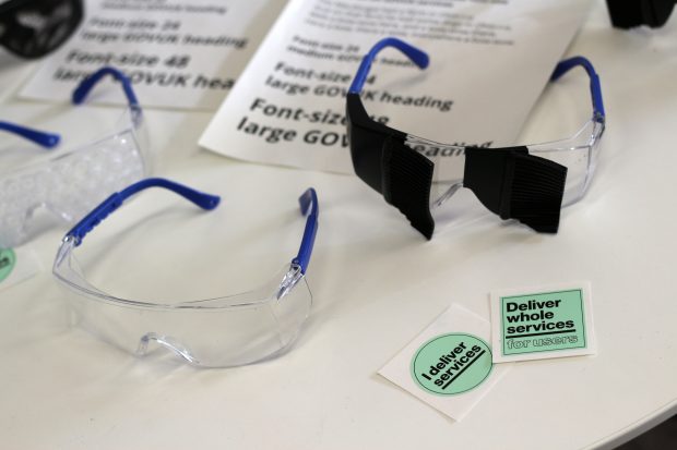 Three pairs of modified glasses and stickers which read "I deliver services" and "Deliver whole services for users".
