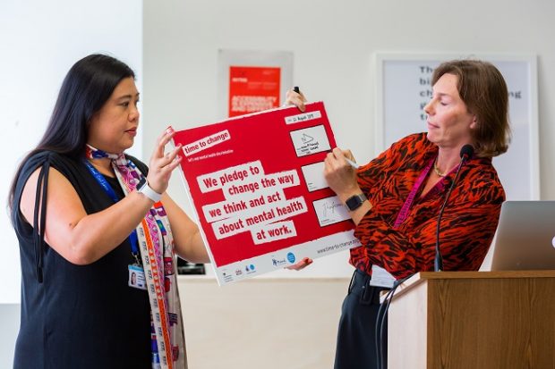 Alison Pritchard holds and signs the Time to Change pledge.