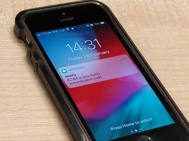 A mobile phone showing a notification of a text message having been received