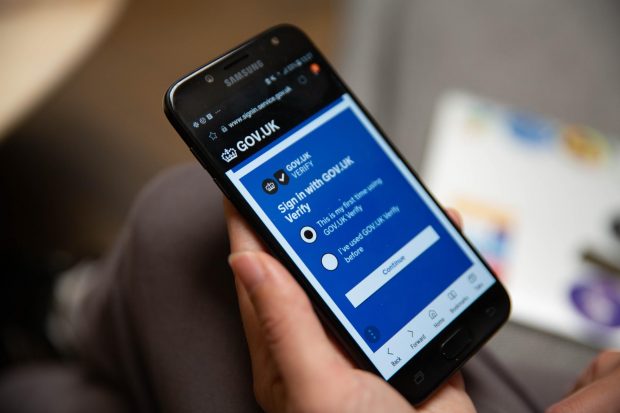 A user on a smart phone on the sign-in page for GOV.UK Verify.