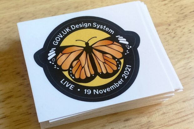 GOV.UK Design System live sticker with a picture of a monarch butterfly and the pass date (19 November 2021).