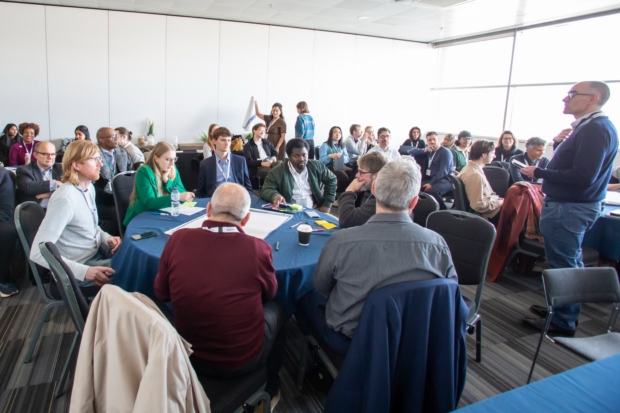 Rob Tabb, the lead for Liverpool’s Office for Public Sector Innovation, stands addressing a room full of council practitioners sat around tables at a workshop organised by GDS Local at the Innovation 2026 conference.